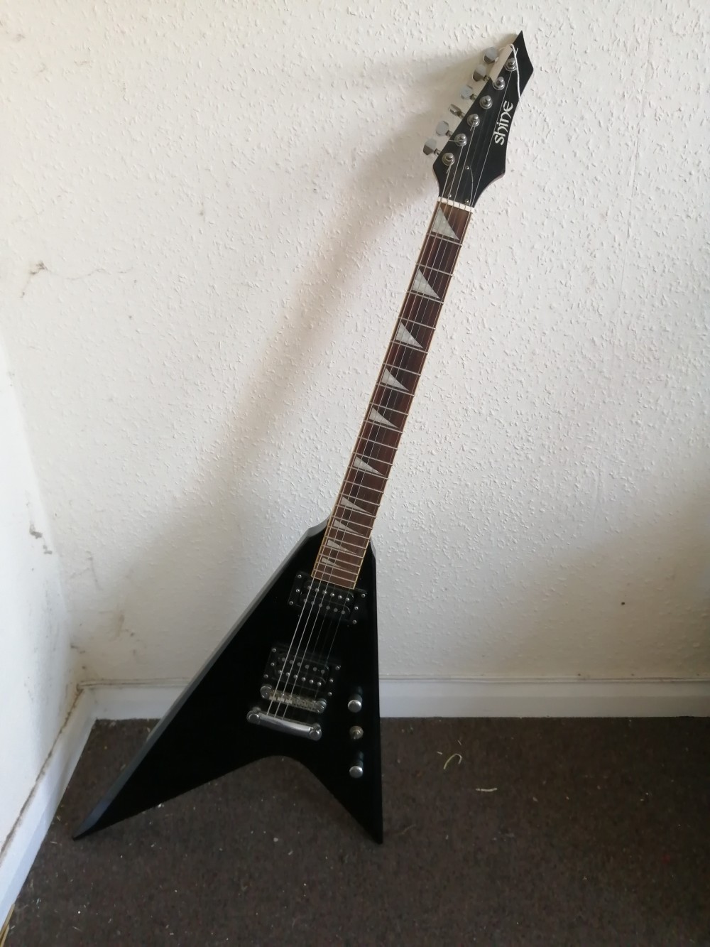 A Shine Offset Flying-V style electric guitar